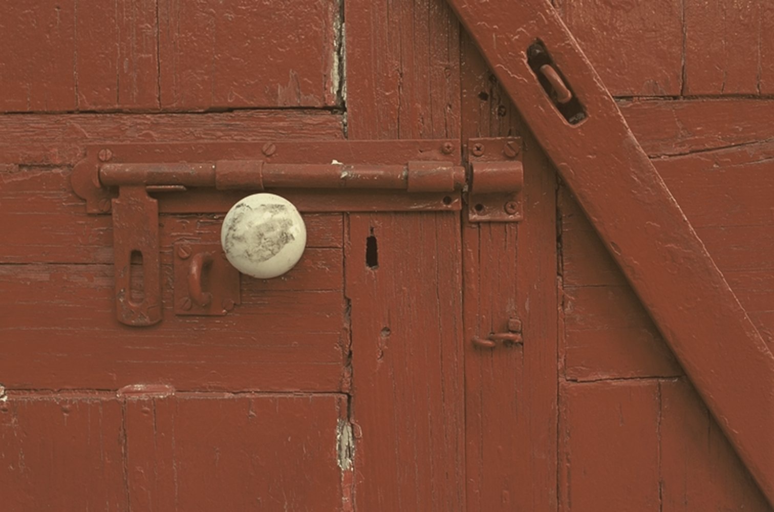 Red painted door with a porcelain knob