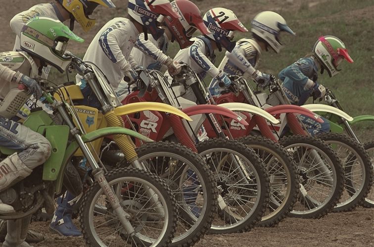 Riders lined up at a start gate