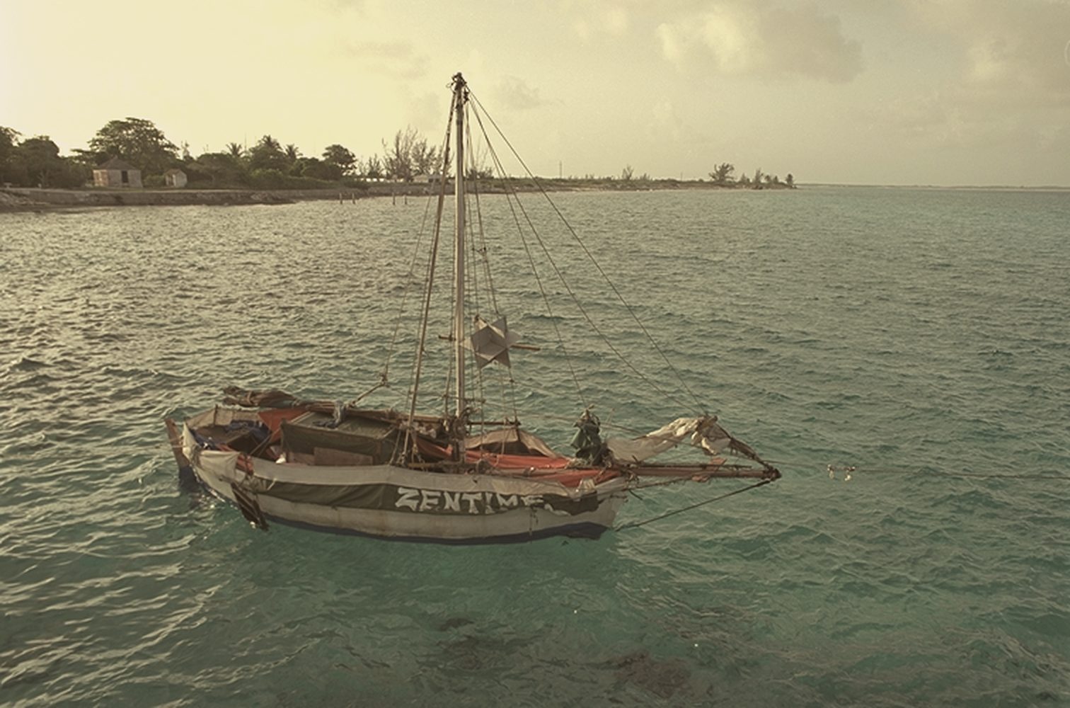 Wooden sailboat in turquoise water