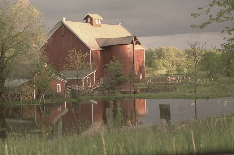 Red barn reflected in a pond